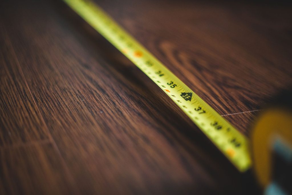 A tape measure on a wooden surface.